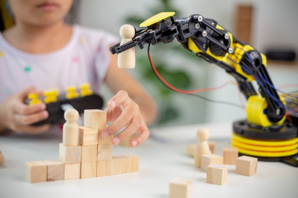 STEM education concept. Asian students learn at home by coding robot arms in STEM,